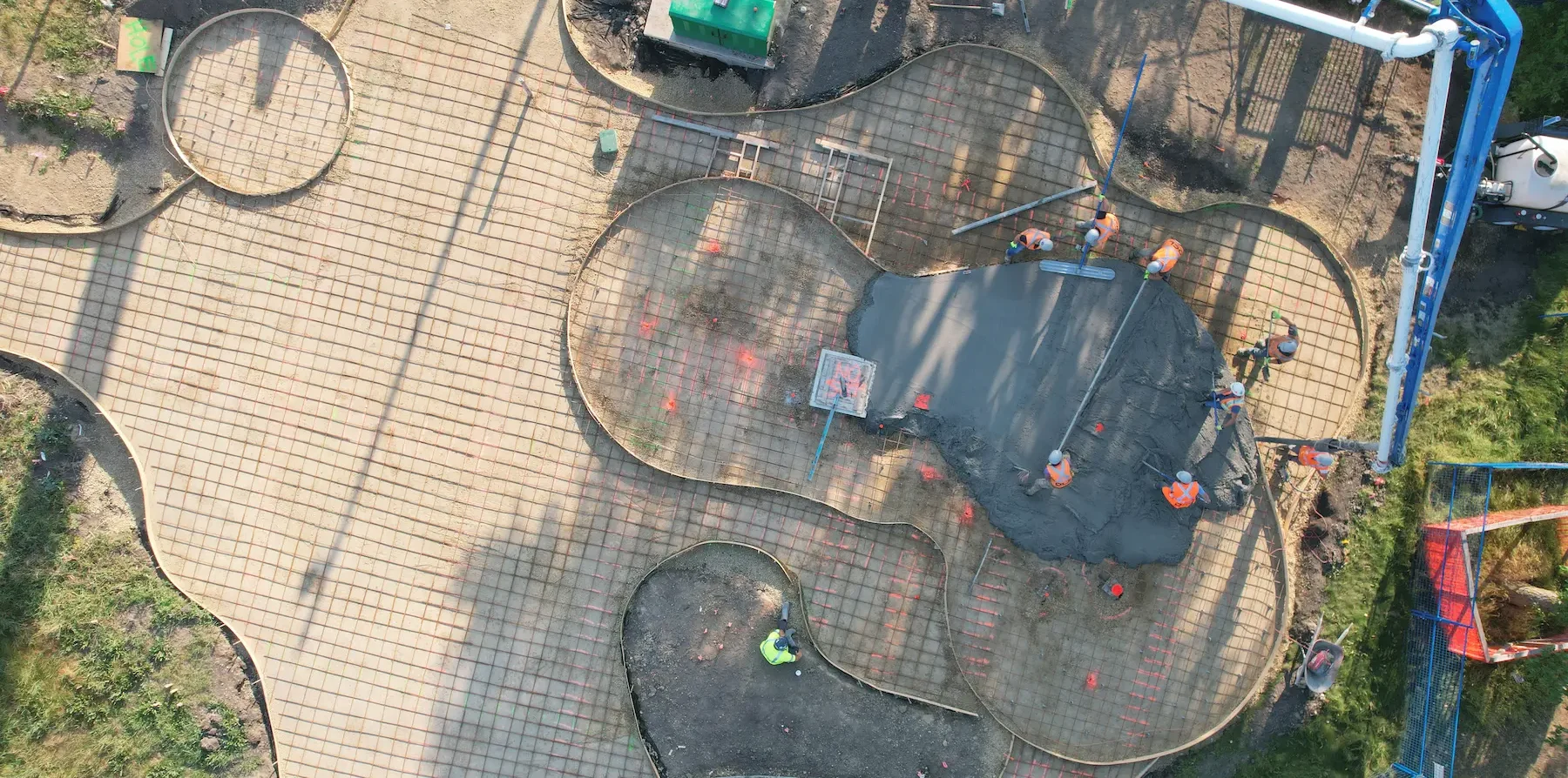 Aerial view of urban park with skatepark, playground, drainage and green spaces