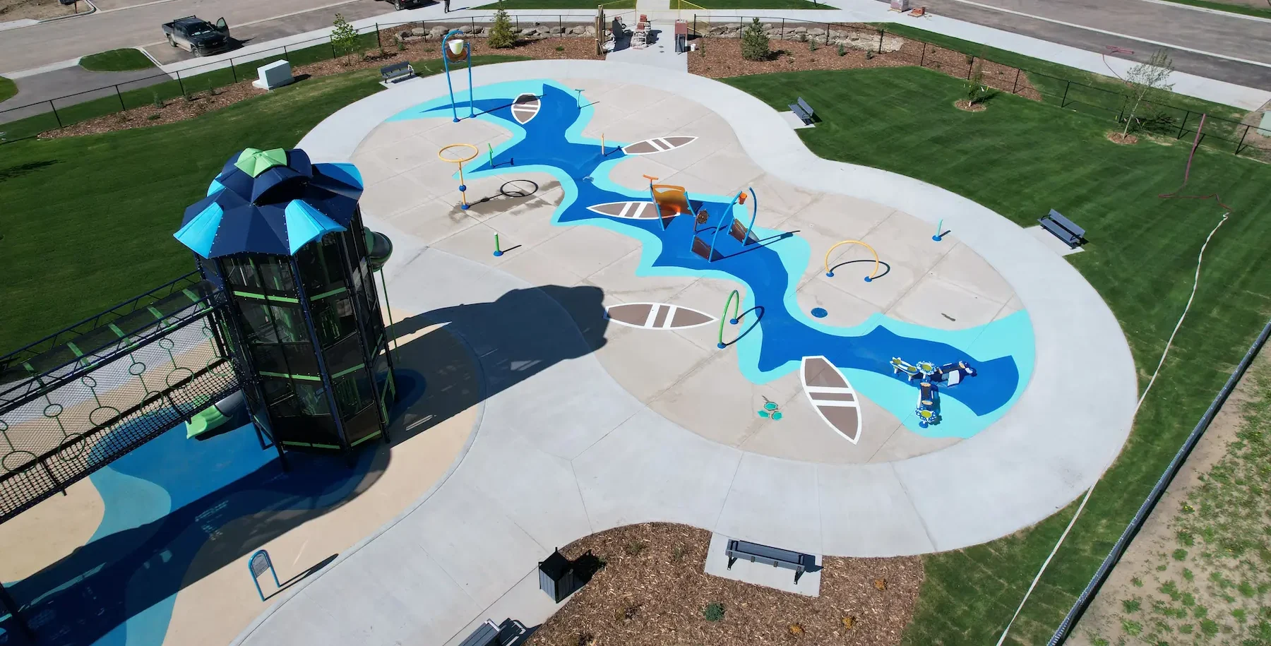 Aerial view of urban park with skatepark, playground, drainage and green spaces