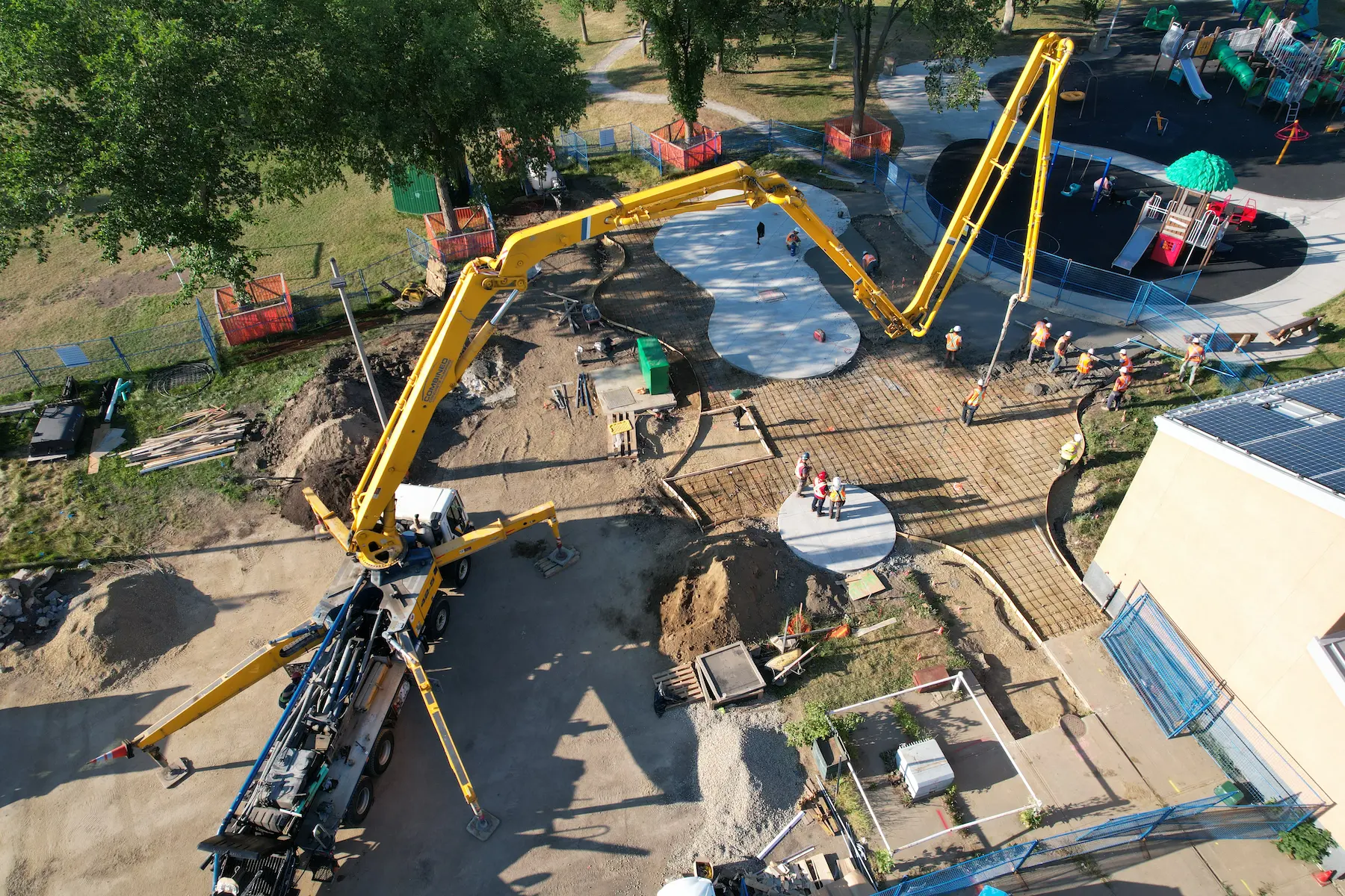 Aerial view of urban park with skatepark, playground, drainage and green spaces
