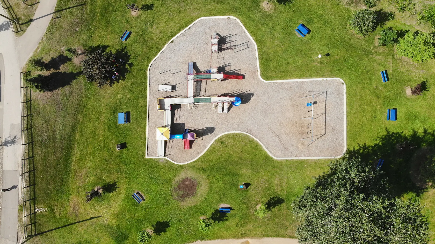 Aerial view of urban park with skatepark, playground, drainage and green spaces